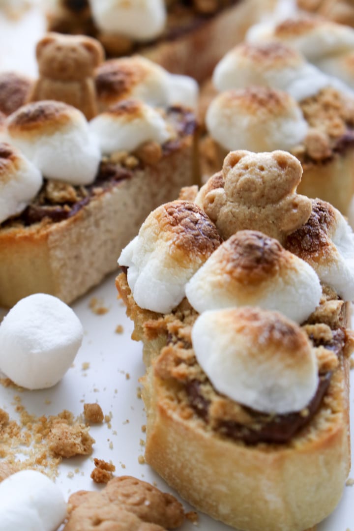 close up shot of hazelnut crostini with teddy bear graham cracker and toasted marshmallow on top