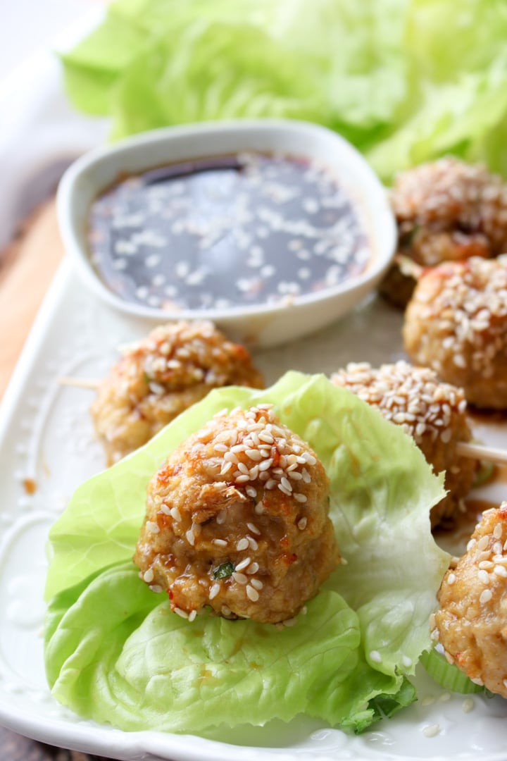 small chicken meatballs sitting on a piece of lettuce