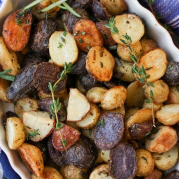 white baking dish filled with roasted baby potatoes