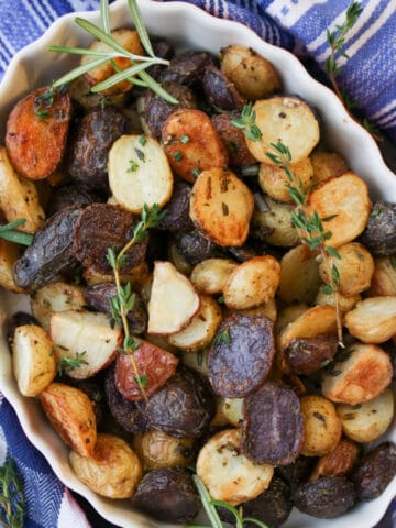 white baking dish filled with roasted baby potatoes