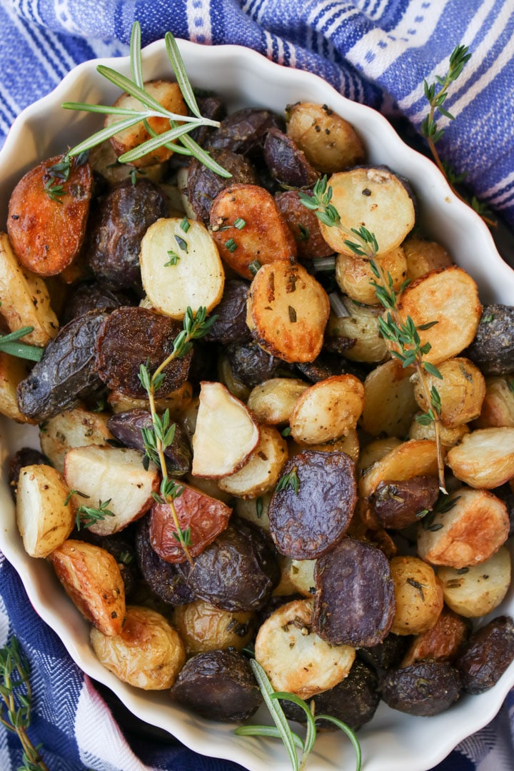 white baking dish filled with roasted baby potatoes