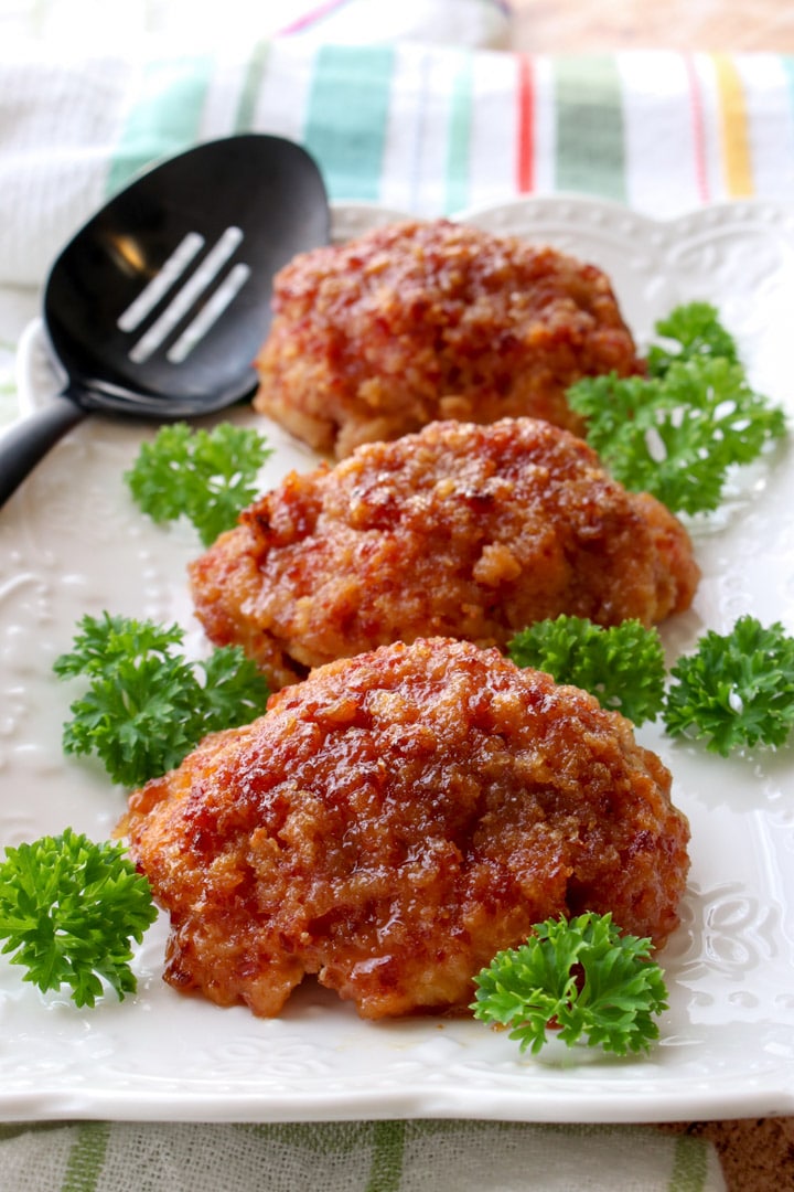 Three ham loaves on a white plate garnished with parsley