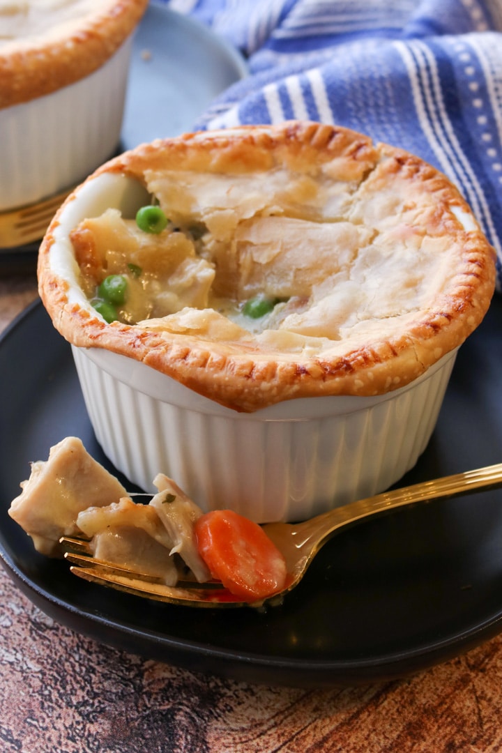 Ramekin or chicken pot pie with a fork full on the side