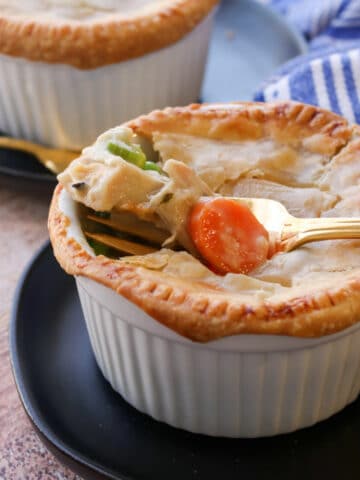 Ramekin or chicken pot pie with a fork full on top