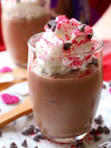 Silken tofu chocolate mousse in a dessert dish topped with whipped cream and sprinkles