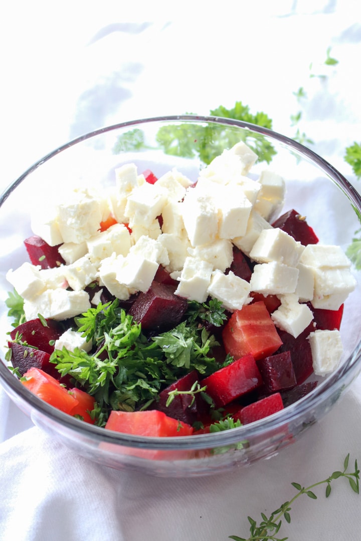 bowl of roasted beets, fresh herbs, and feta cheese cubes