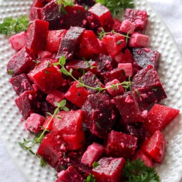 White plate with red beet salad