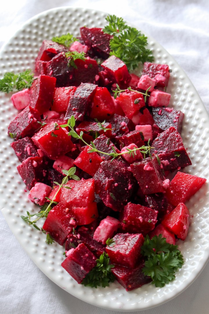 White plate with red beet salad