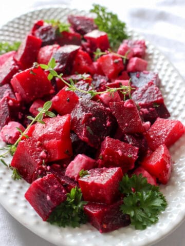 White plate with red beet salad