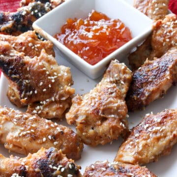 platter of pbj wings with a dish of apricot jam