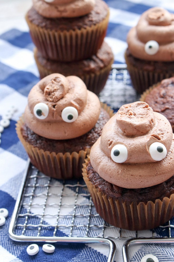 poop emoji cupcakes sitting on a small baking rack