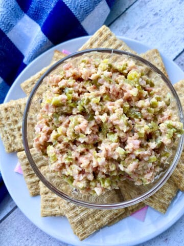 Bowl of ham salad surrounded by crackers