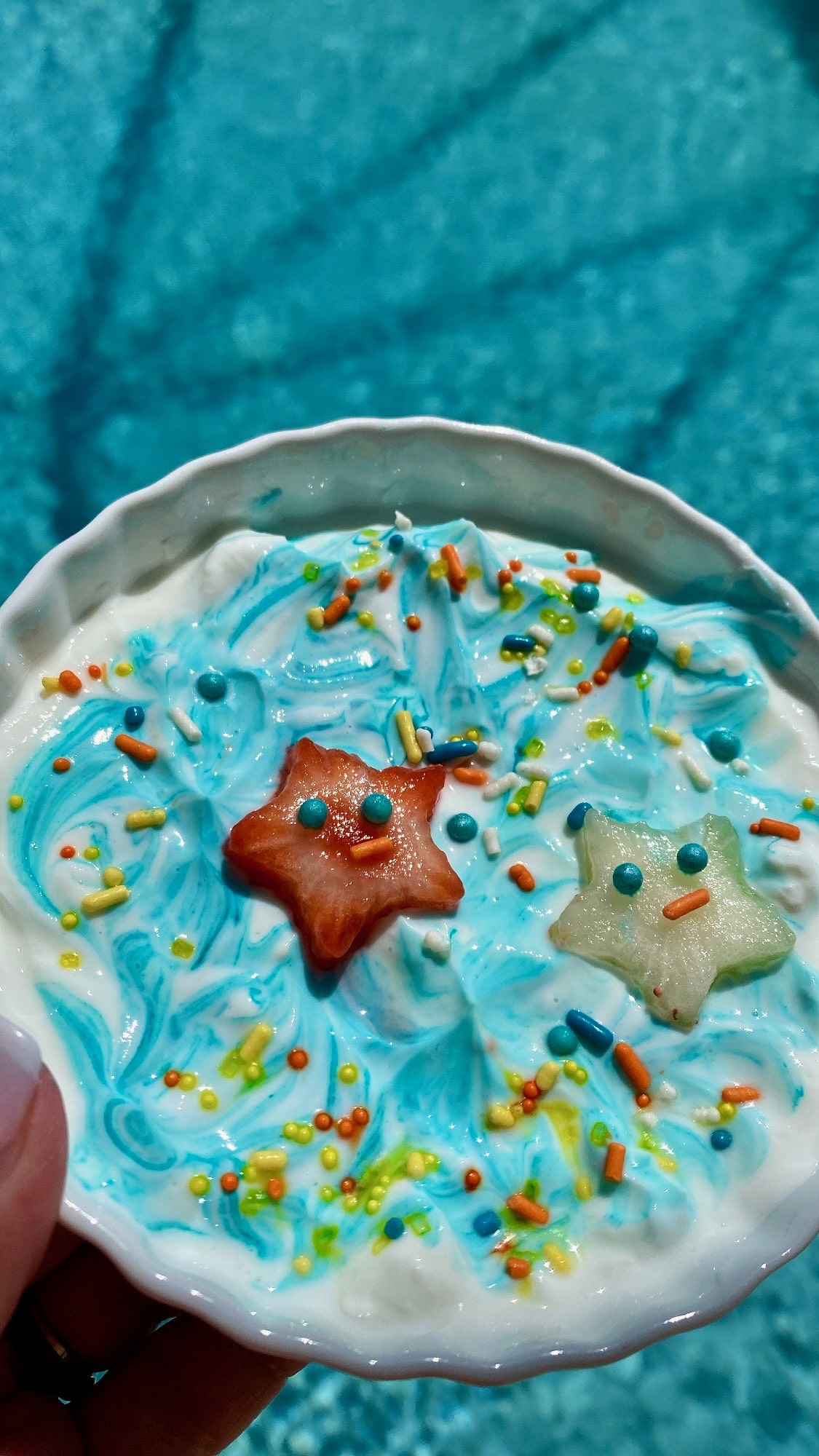 strawberry star cutouts on blue colored yogurt