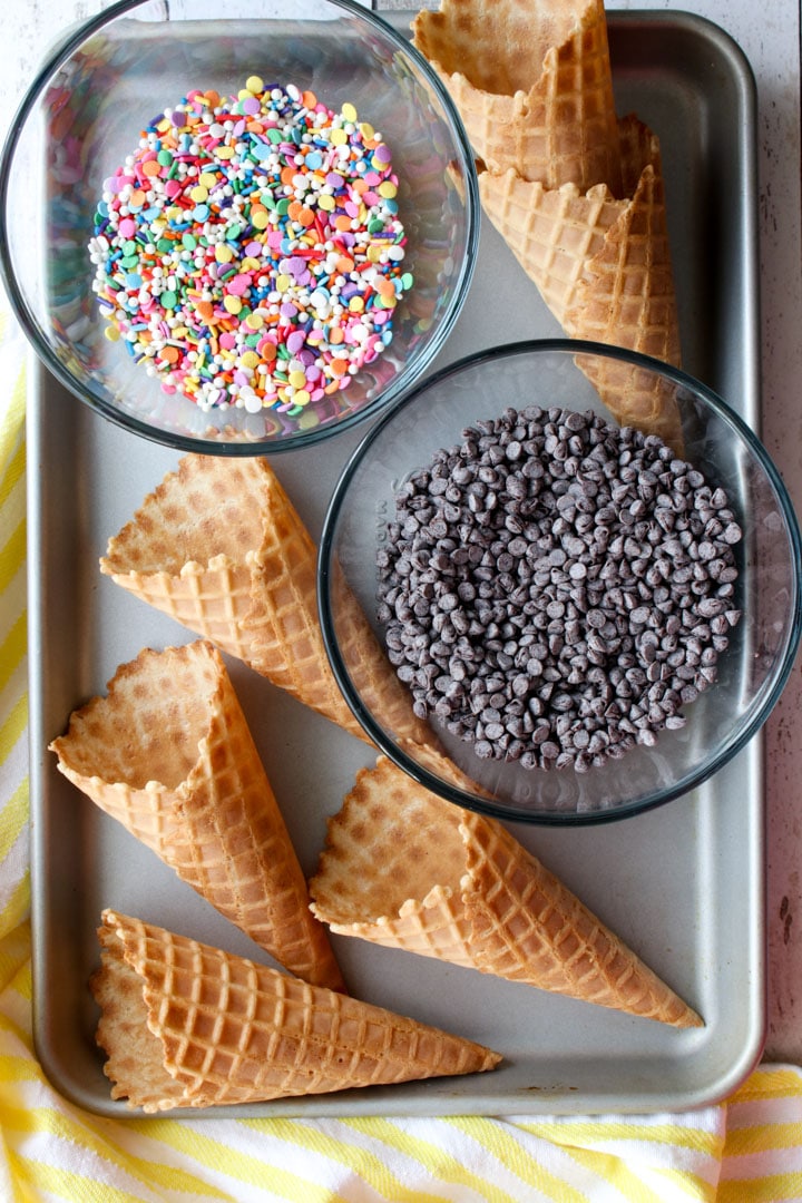 WAFFLE CONES, SPRINKLES AND CHOCOLATE CHIPS ON A COOKIE SHEET