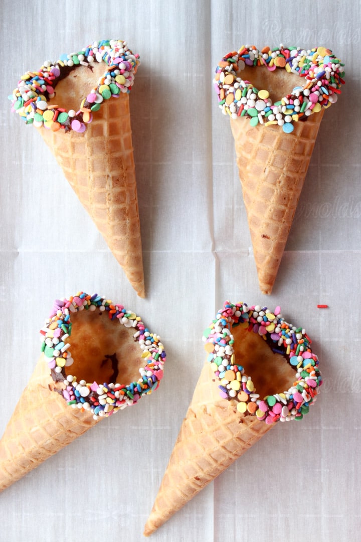 4 waffle cones with chocolate and sprinkle covered rims