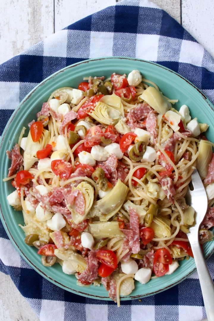 bowl of spaghetti salad on a blue and white checked cloth