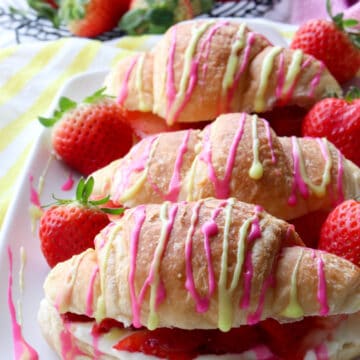 platter of croissants drizzled with pink and yellow glaze