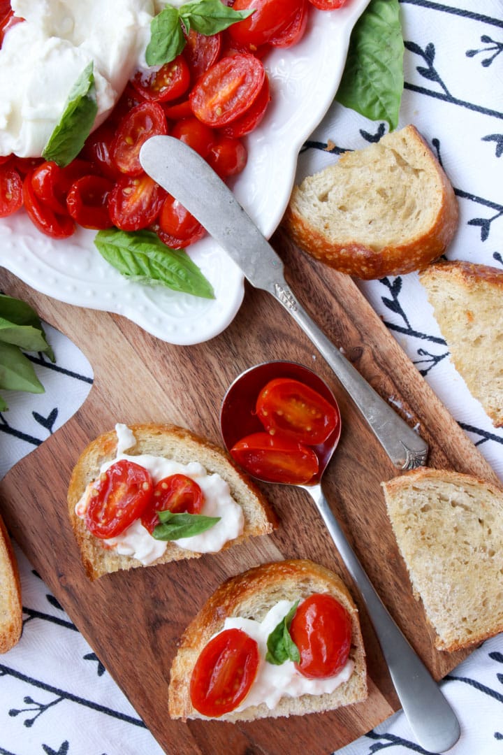 slices of toast with burrata cheese and tomatoes