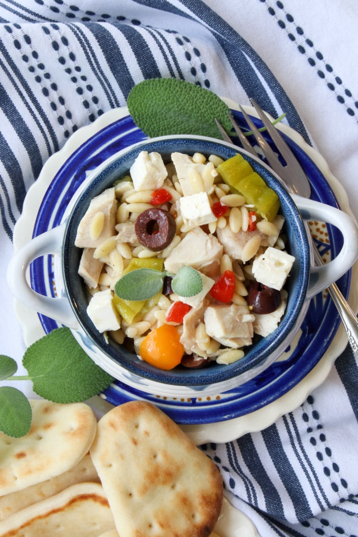 overhead shot of bowl of greek orzo chicken pasta salad