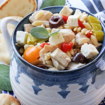 BLUE AND WHITE BOWL FILLED WITH GREEK ORZO PASTA SALAD
