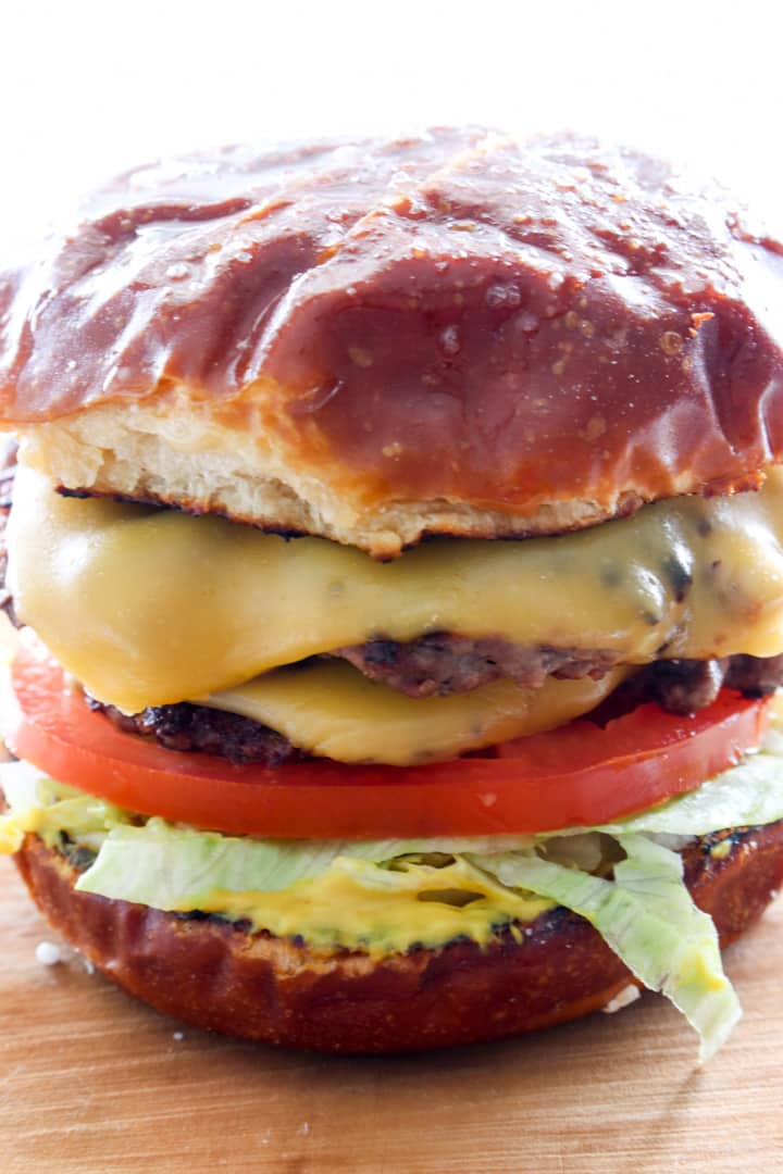 close up of a double decker cheeseburger