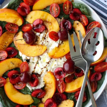 round platter of burrata, nectarines, cherries, tomatoes, spinach