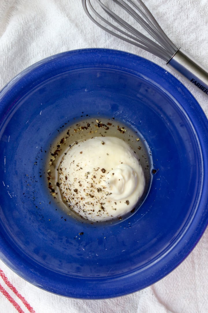 blue bowl filled with mayo, vinegar, sugar