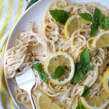 dish of pasta with a fork that has pasta twirled around the prongs