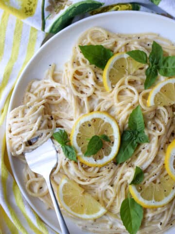 dish of pasta with a fork that has pasta twirled around the prongs