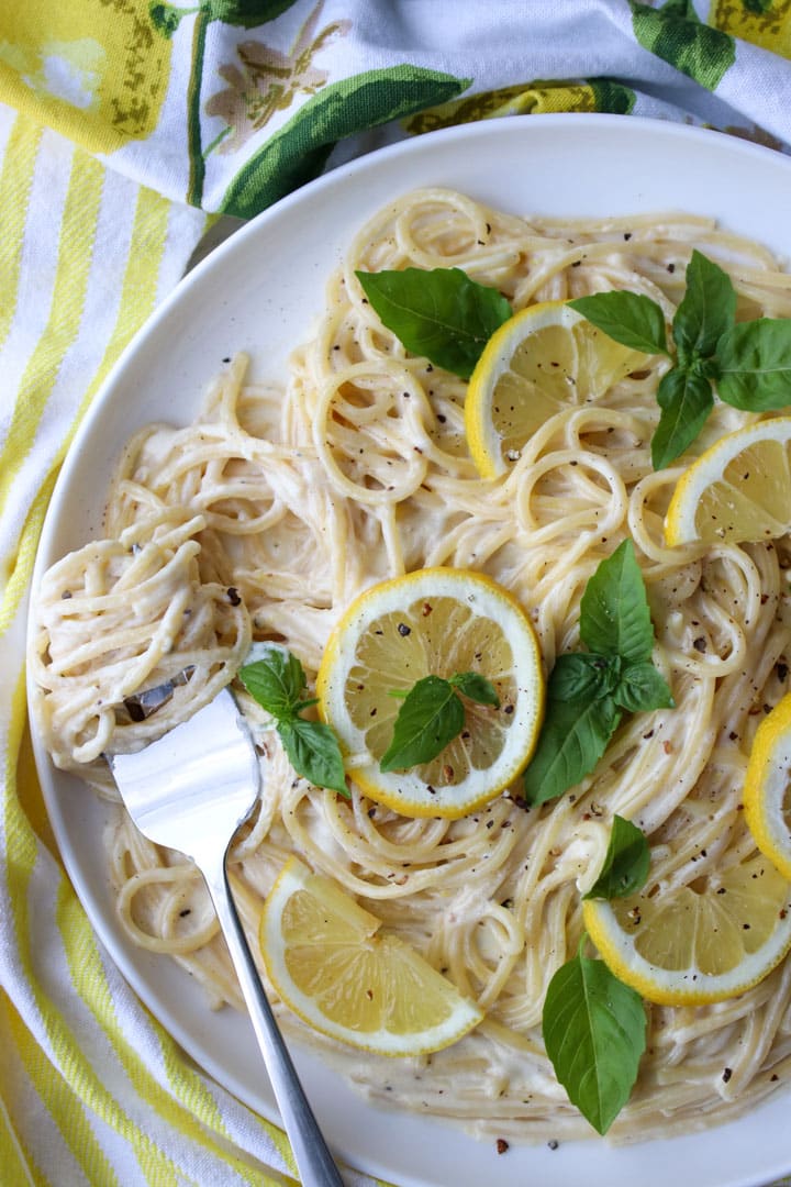 dish of pasta with a fork that has pasta twirled around the prongs