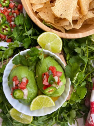 avocados in a bowl and topped with salsa