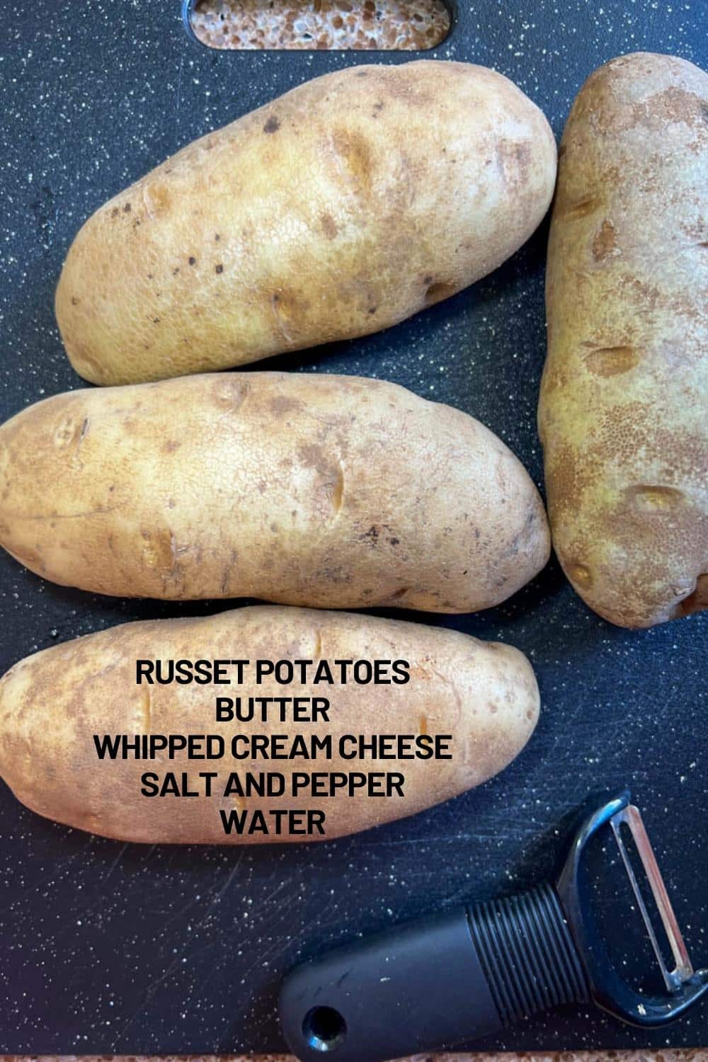 SHOT OF 4 RUSSET POTATOES WITH INGREDIENTS TO MAKE MASHED POTATOES LISTED ON ONE OF THEM