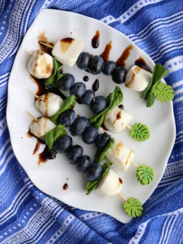 Blueberry caprese skewers on a plate