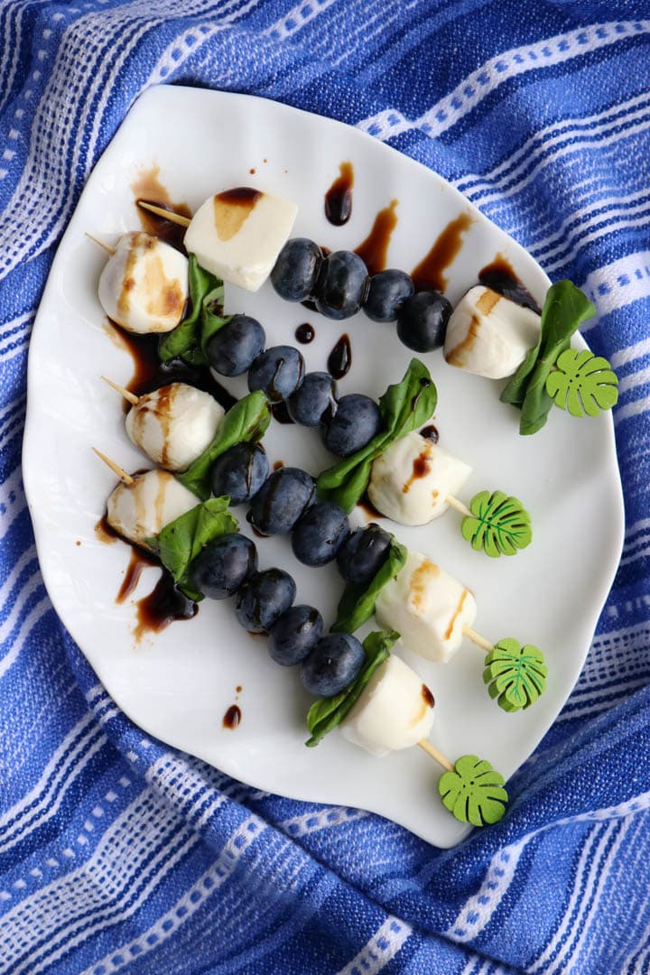 Blueberry caprese skewers on a plate