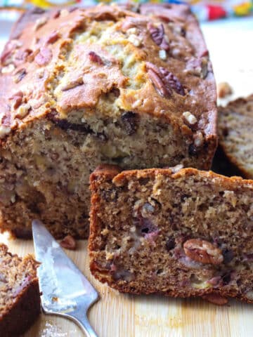 load of banana bread with a slice leaning on it