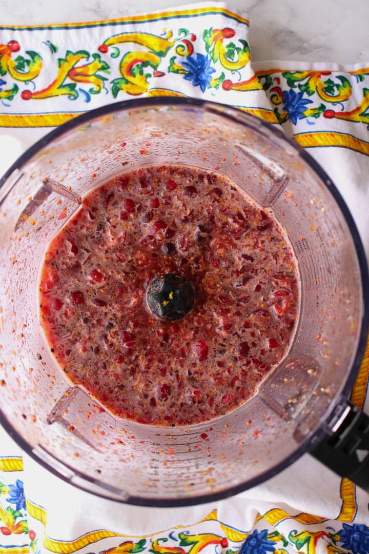 blender bowl with cranberry marinade.