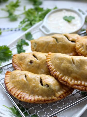 plate of beef curry samosa hand pies