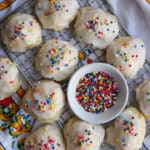 Italian wedding cookies on a rack with a bowl of sprinkles