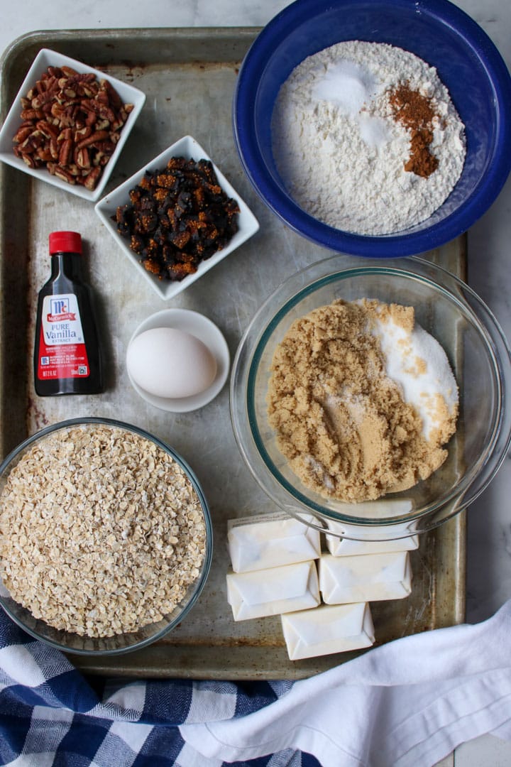 cookie sheet with the ingredients to make oatmeal fig pecan cookies