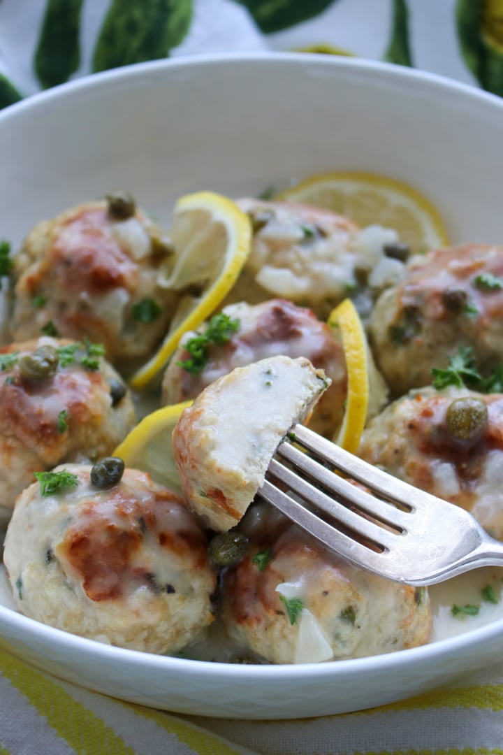 Lemon Caper chicken meatball cut in half on a fork