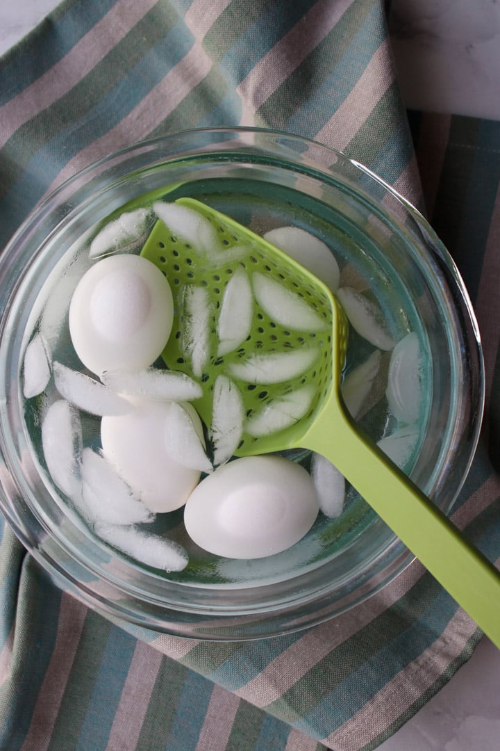 eggs in a clear bowel filled with water and ice cubes