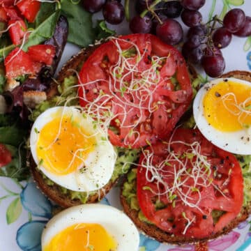 salad with leaf lettuce, ripe tomatoes, and soft boiled eggs