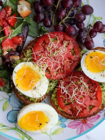 salad with leaf lettuce, ripe tomatoes, and soft boiled eggs