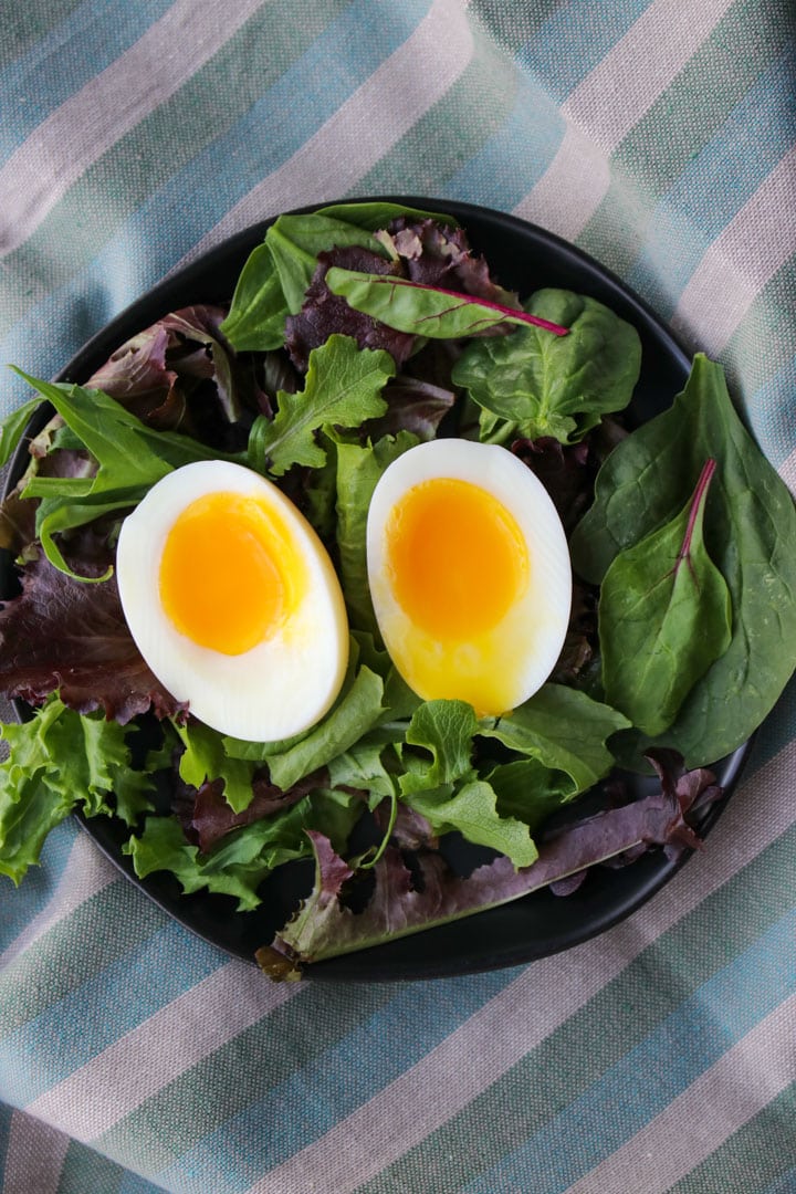 soft boiled eggs on a bed of lettuce