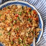 Large bowl of rotisserie chicken fried rice with a large serving spoon on the right side