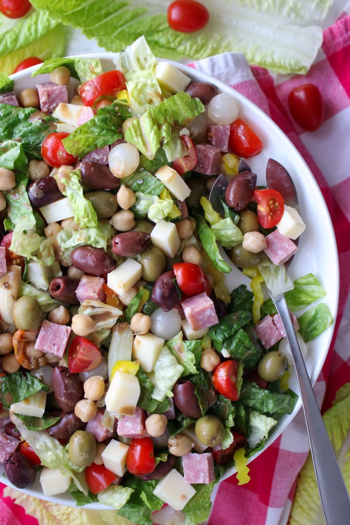 Italian chopped salad on a large platter with a spoon