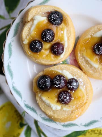 three lemon blueberry danish on a small plate