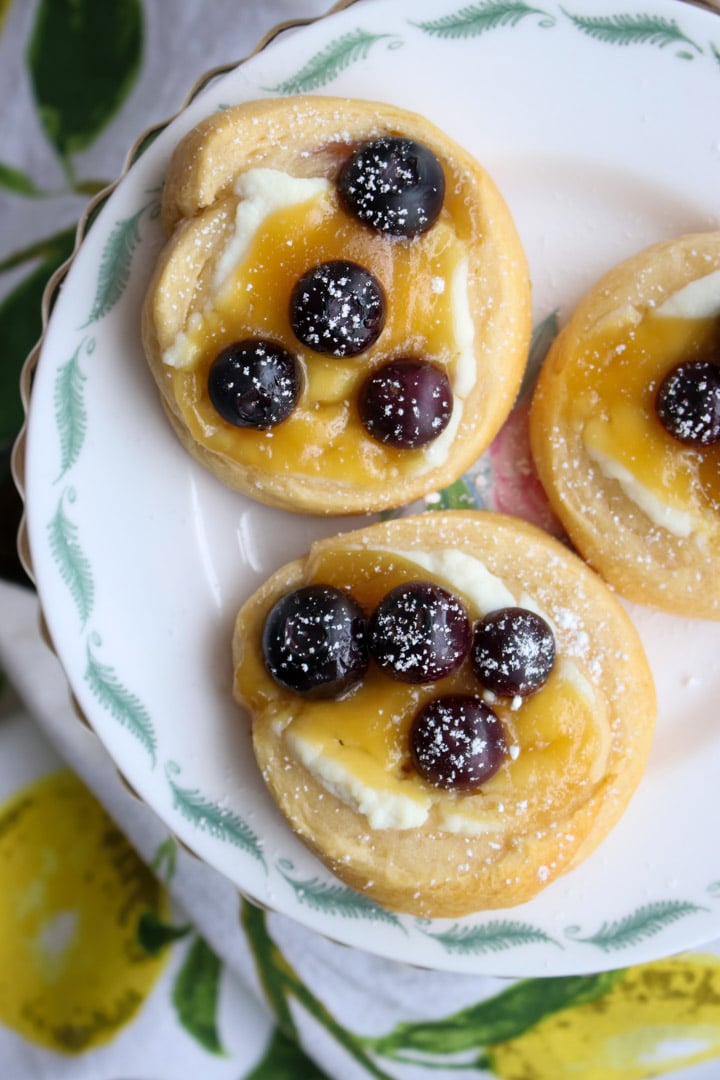 three lemon blueberry danish on a small plate