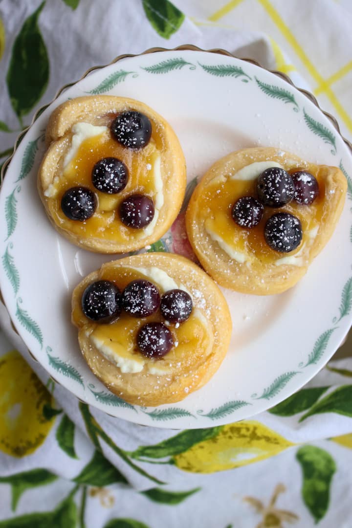 three lemon blueberry danish on a small plate