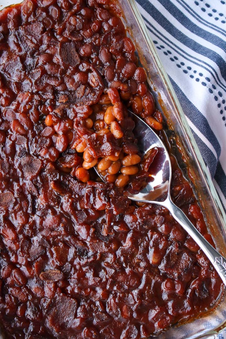 baked beans and a serving spoon in a baking dish 